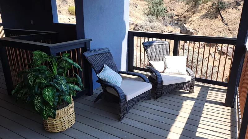 Wicker chairs with cushions on the deck at the residence