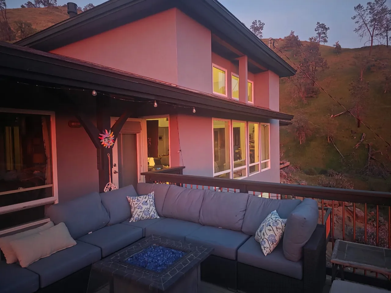 The residence at dusk, with the deck lit