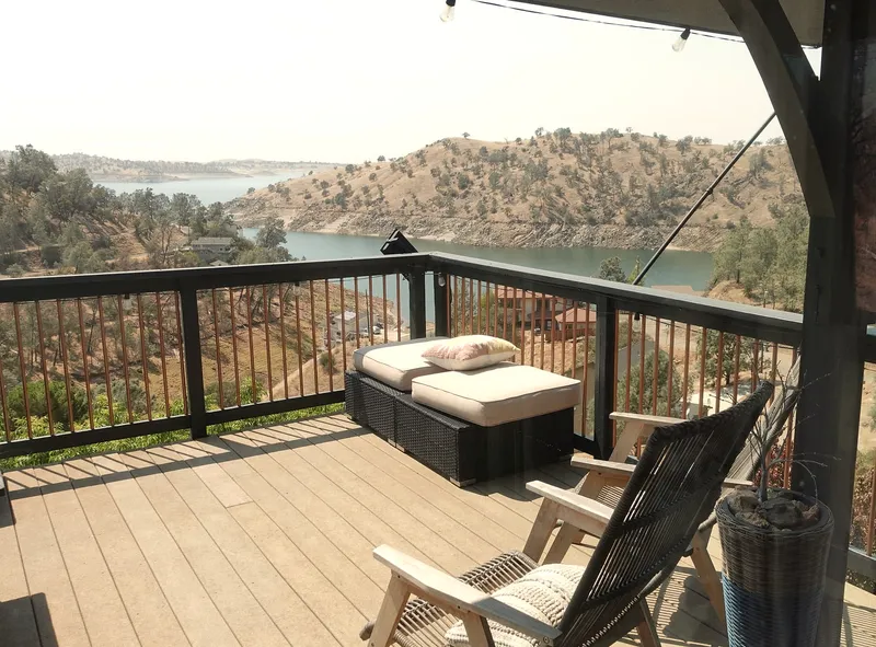 Two deck chairs and a cushioned ottoman looking out over Millerton